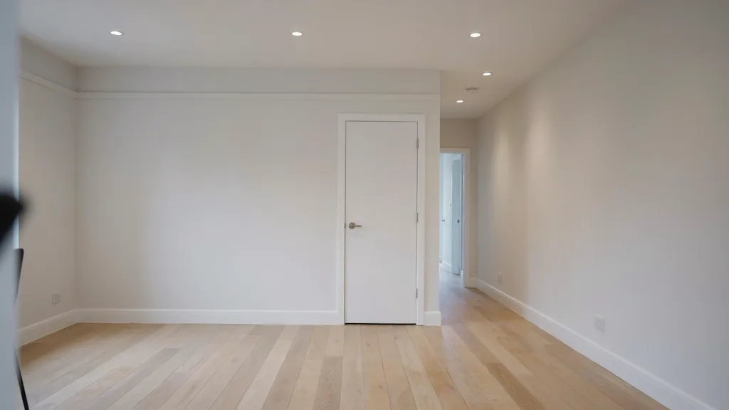 freshly painted dining room hallway walls trim doors smooth finish neutral tones empty space even lighting sharp edges modern interior.