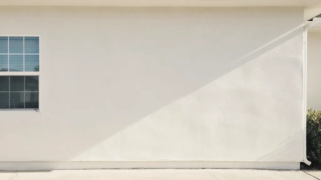 Fully cured exterior painted wall with durable smooth finish shown in bright daylight on clean residential exterior surface.