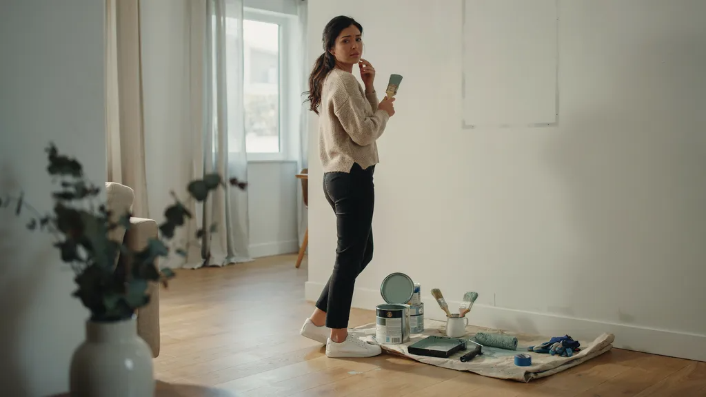 Homeowners considering whether to use leftover exterior paint for an indoor wall project in a modern room.