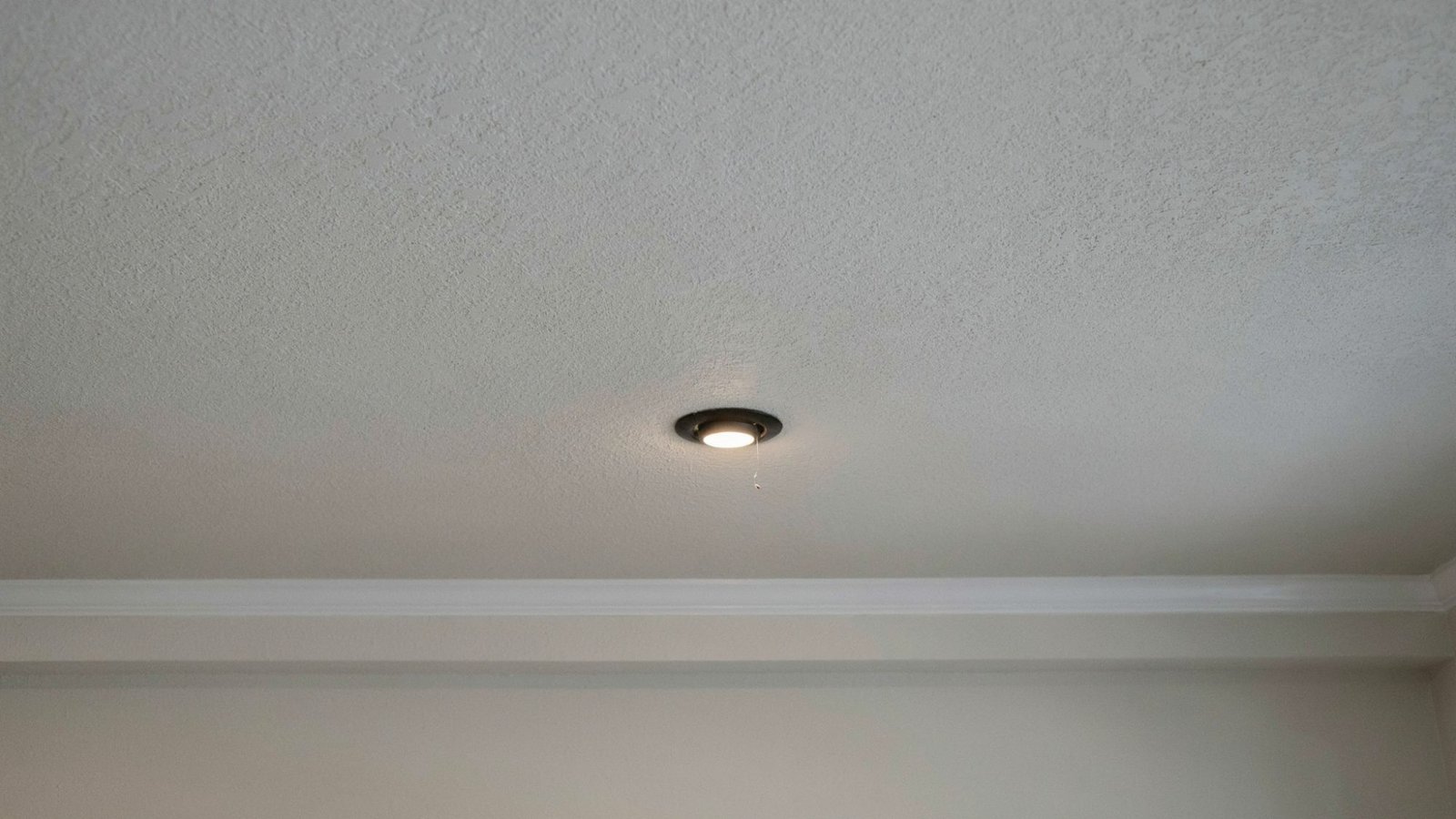 Spray sand ceiling texture with grainy finish.