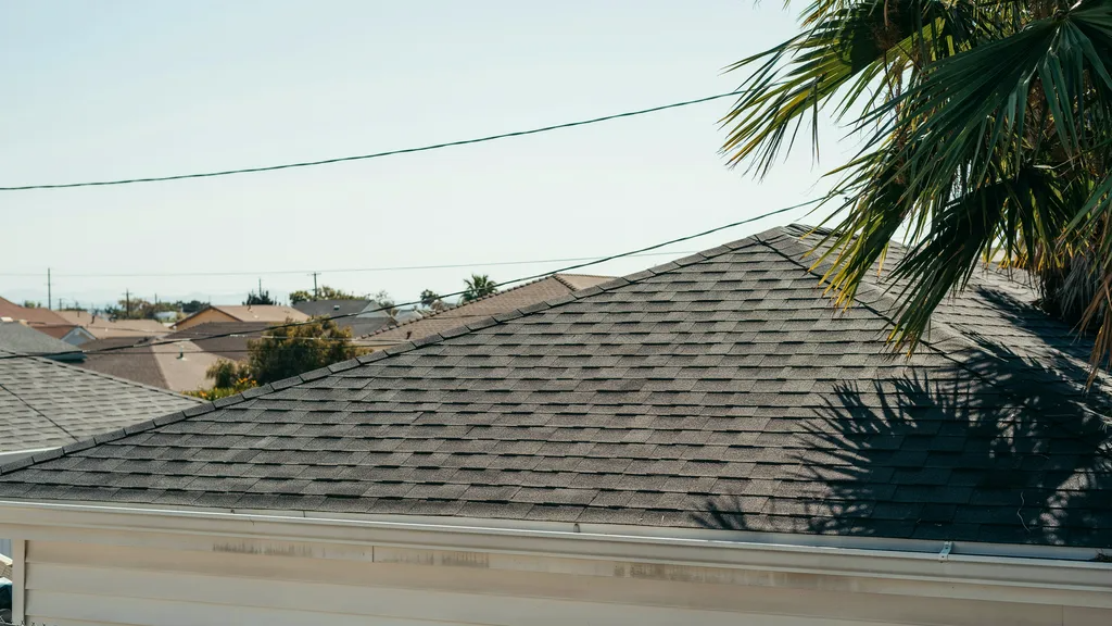 Dark roof absorbing significant heat in a hot climate.