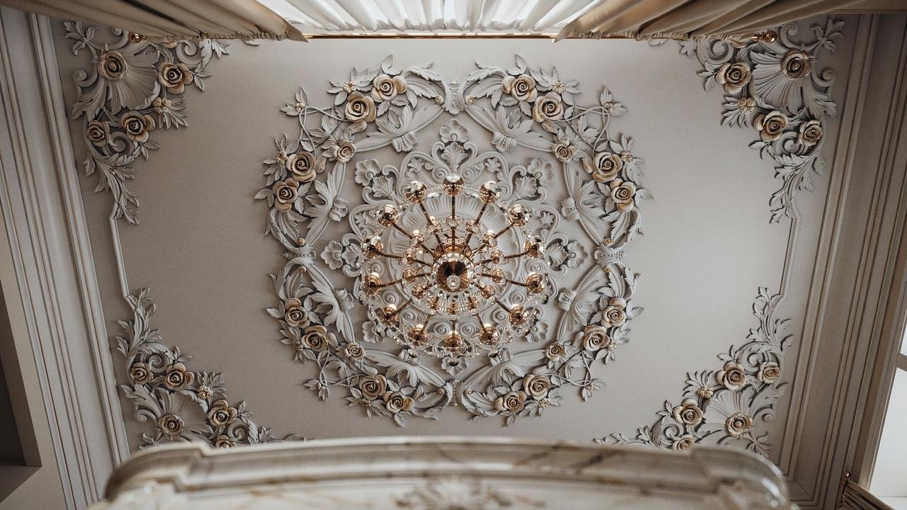 Floral ceiling texture surrounding a chandelier.