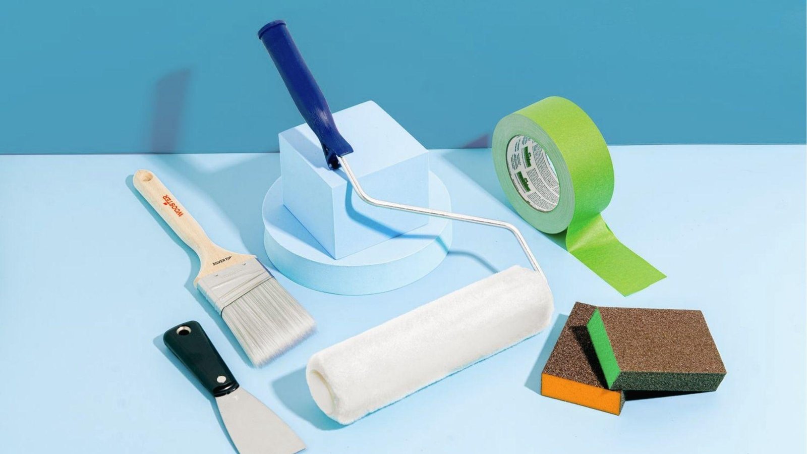 Important faux painting tools displayed brush, roller, scraper, tape, sponges for finishes