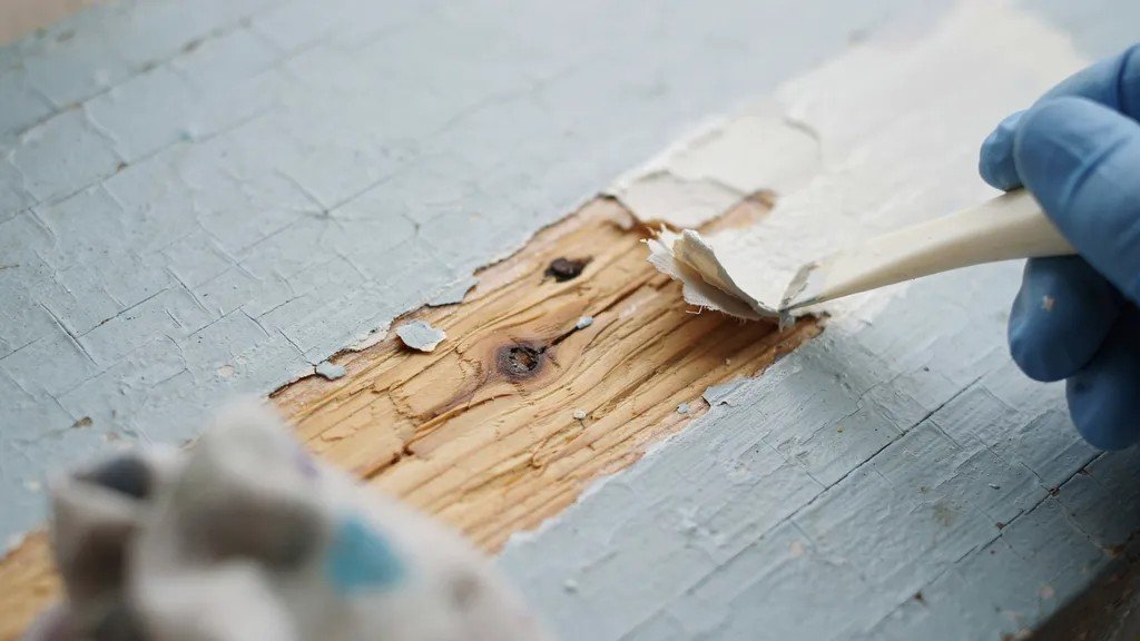 Testing paint removal after paint stripper has softened the paint