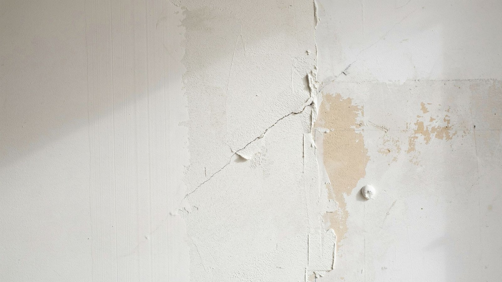 Interior wall showing different textures finishes and repaired areas highlighting key factors that affect overall painting cost and project complexity.