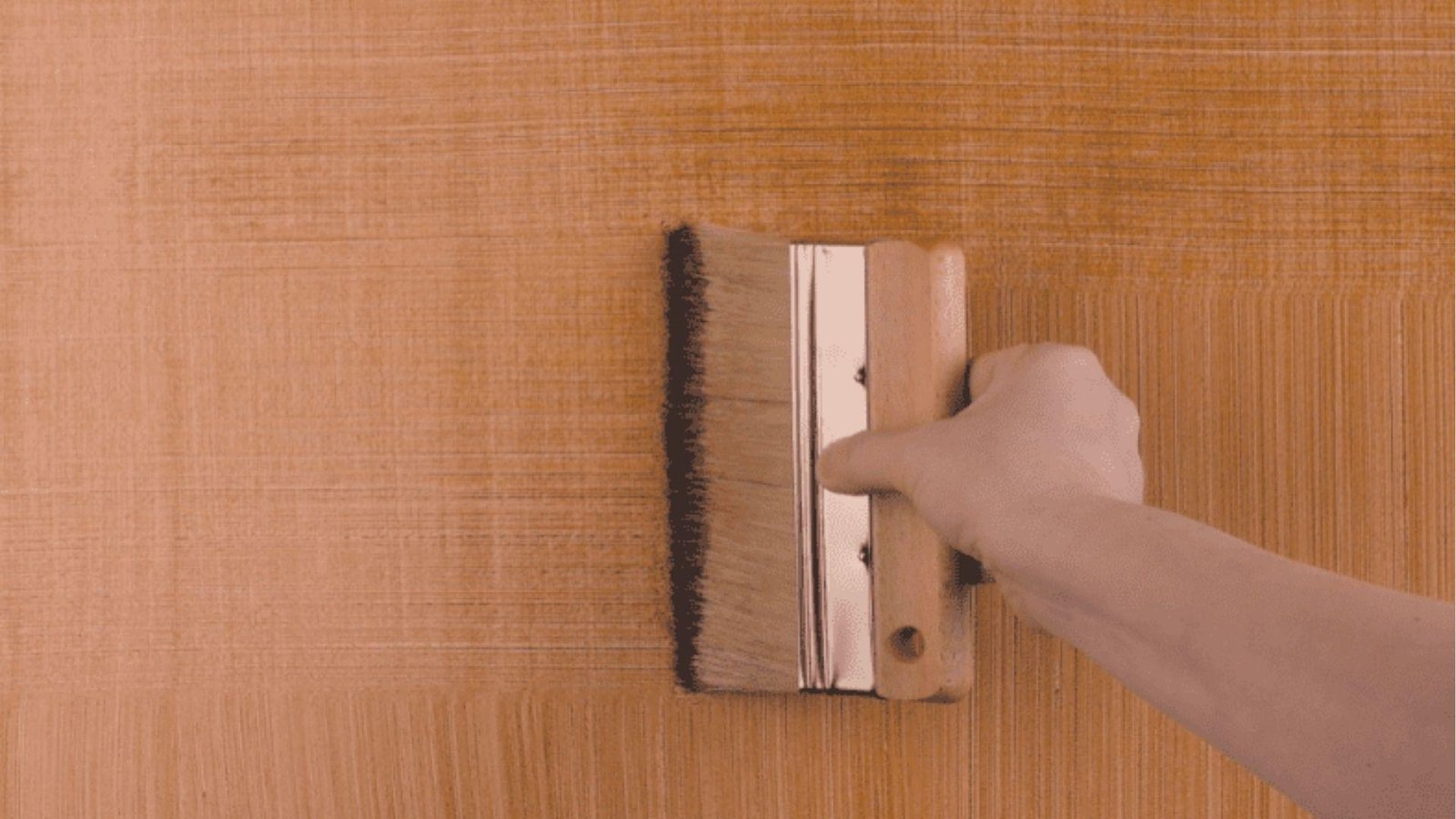 Wide brush adds dark glaze lines on tan base to mimic wood grain, faux bois technique