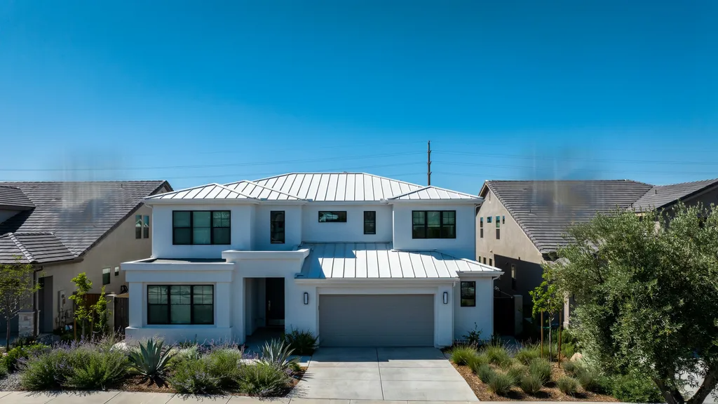 Best roof color for hot climate with a white reflective roof on a sunny day reducing heat absorption.