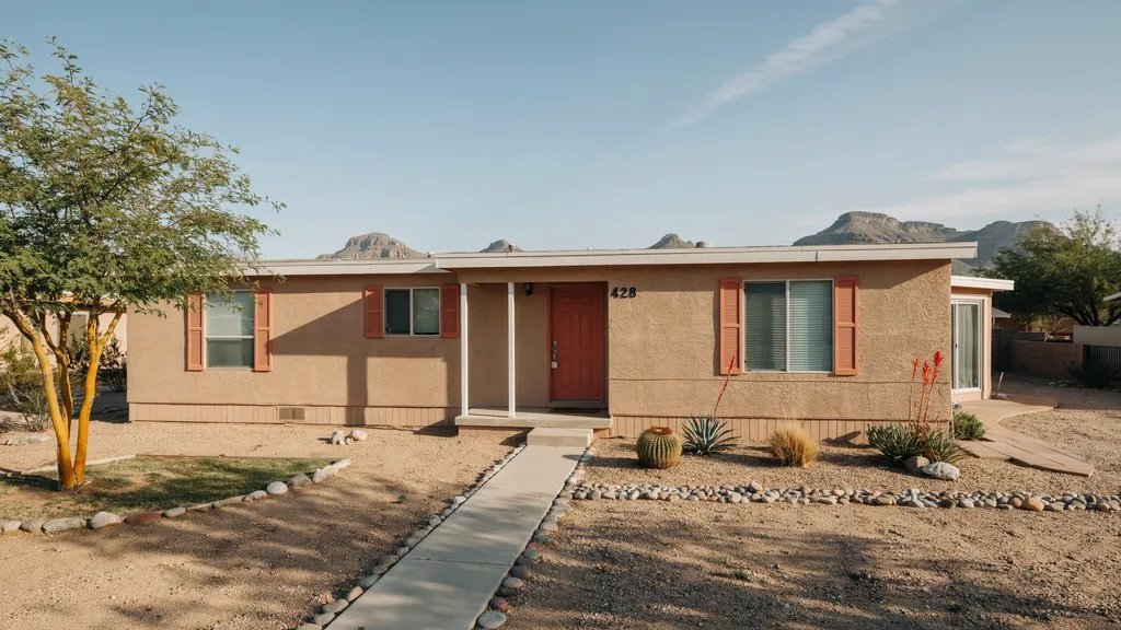 Warm tan mobile home with rust orange accents creating a desert-inspired exterior design.