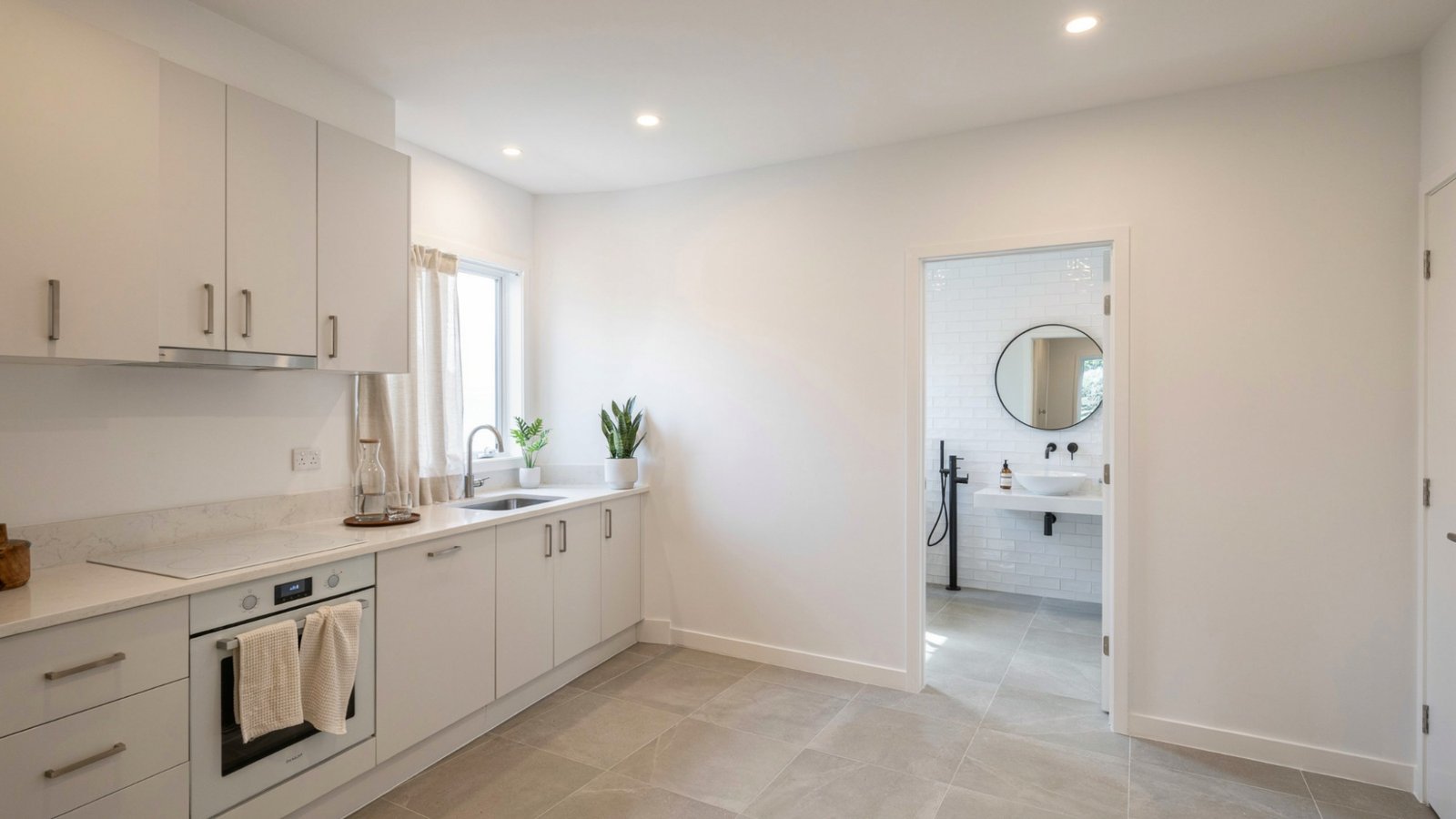 clean painted kitchen cabinets walls smooth finish surfaces no clutter sink tiles minimal design bright lighting moisture resistant coating visible.