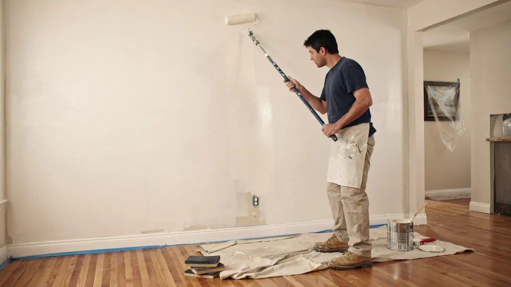 Applying fresh paint evenly to blend with the existing wall color.