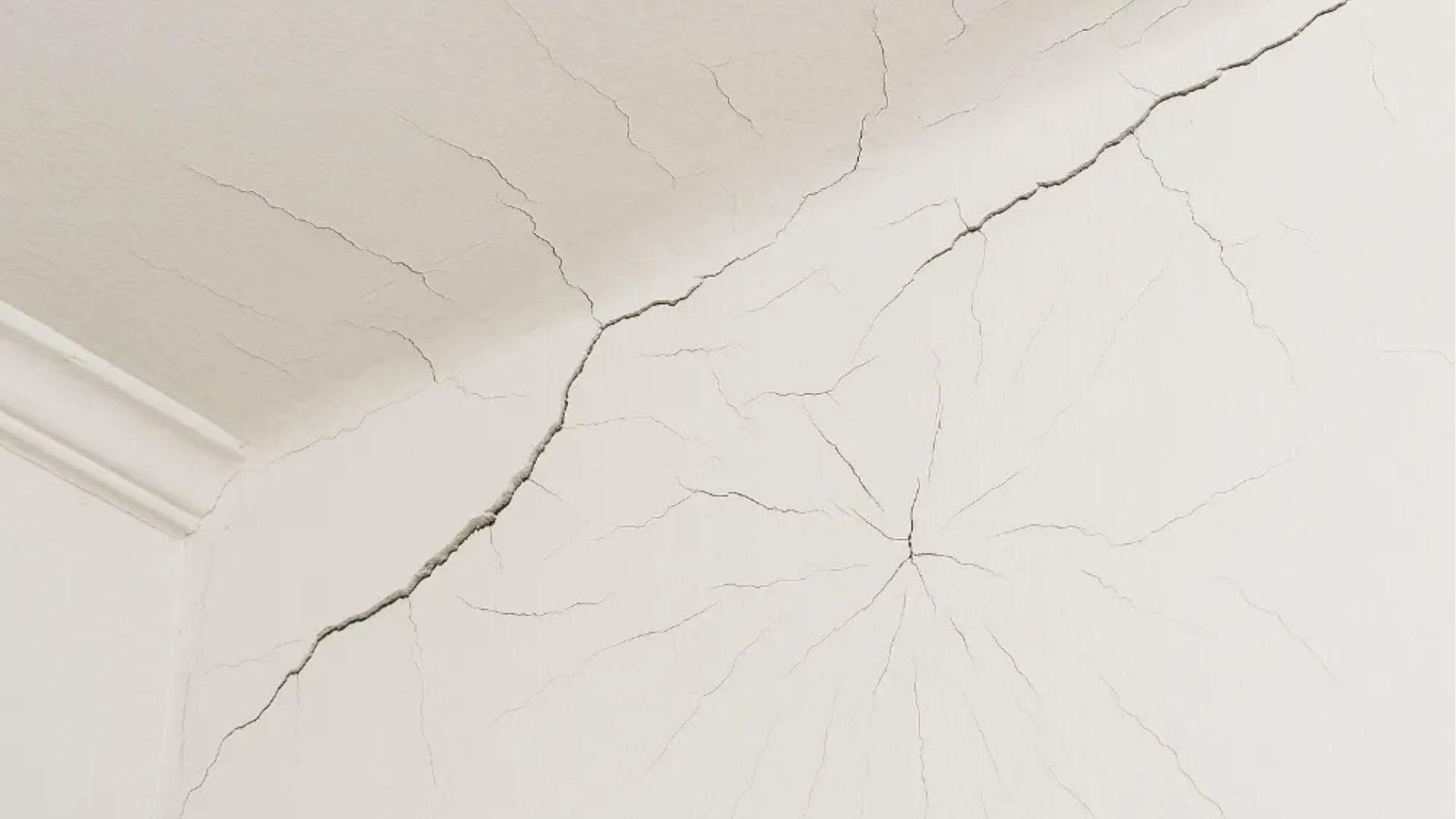Deep ceiling cracks show how moisture or poor prep makes spray paint crack over time