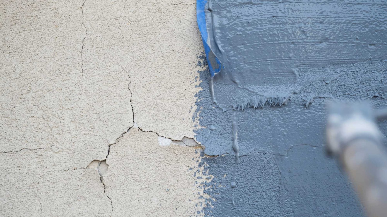 Elastomeric paint covering small cracks in a stucco wall.