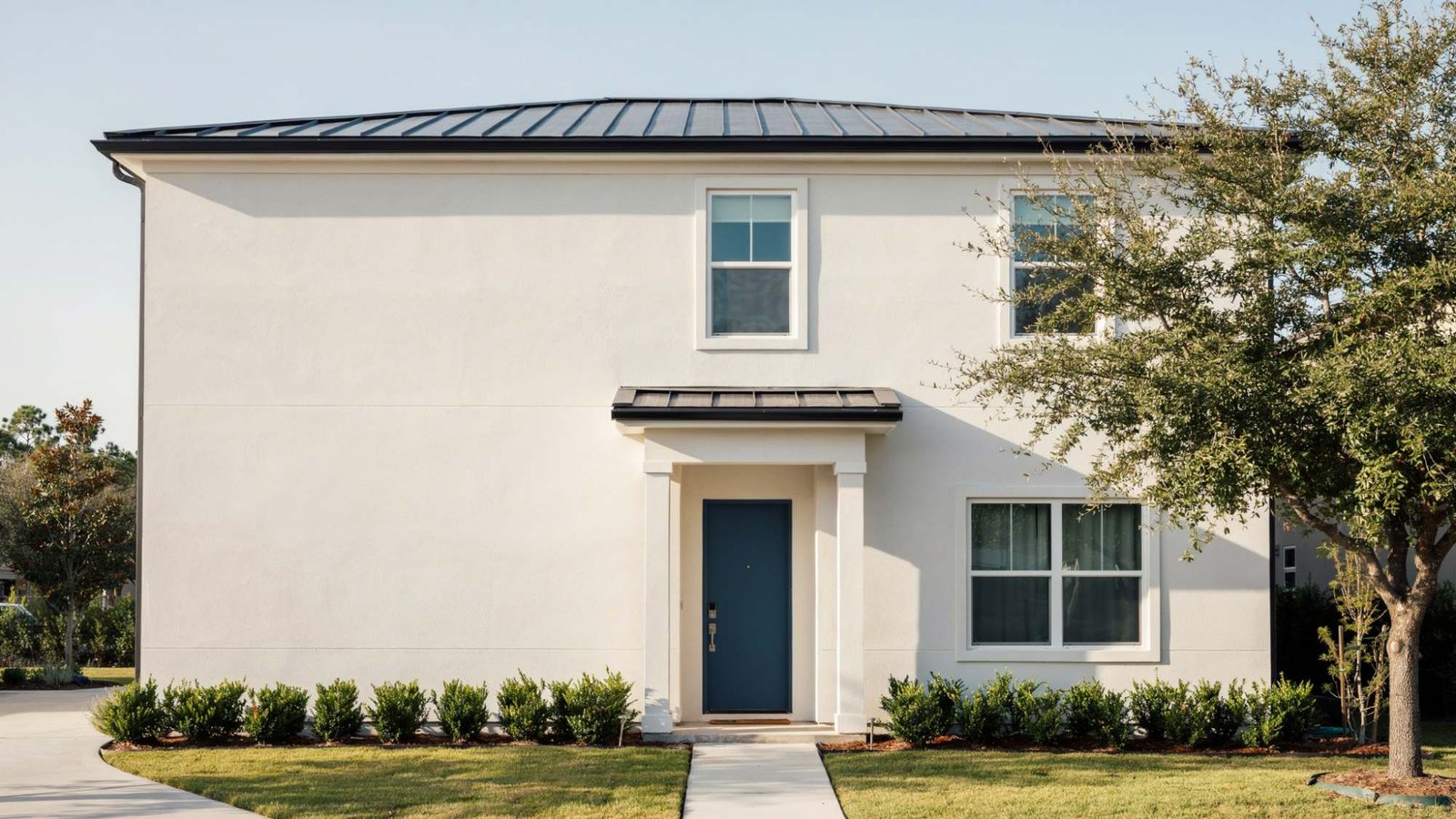 Elastomeric paint applied to a stucco house exterior.
