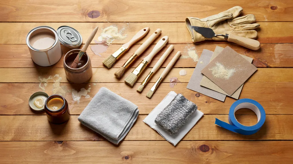 Essential chalk paint distressing tools arranged neatly on a table.